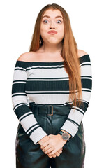 Sticker - Young beautiful redhead woman wearing elegant clothes puffing cheeks with funny face. mouth inflated with air, crazy expression.