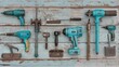© lililia - Various blue power tools are laid out on a weathered, blue, wooden plank surface
