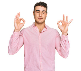 Hispanic young man wearing casual clothes relax and smiling with eyes closed doing meditation gesture with fingers. yoga concept.