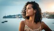 © Daniel - Close-up of a Hispanic woman with curly hair, wearing a summer dress and looking thoughtfull