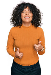 Poster - Young hispanic woman wearing casual clothes success sign doing positive gesture with hand, thumbs up smiling and happy. cheerful expression and winner gesture.