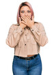 © Krakenimages.com - Hispanic woman with pink hair wearing casual clothes shocked covering mouth with hands for mistake. secret concept.