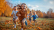 © Prompt World - Group of happy children running through autumn leaves in a park