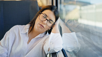 Sticker - Young beautiful hispanic woman sleeping inside train wagon