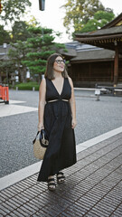 Poster - Confidently posing at fushimi inari taisha, a beautiful hispanic woman wearing glasses, smiles broadly, looking around, captivated by the stunning kyoto temple surroundings.