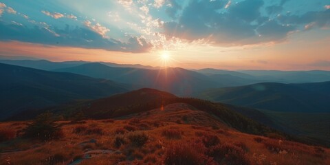 Poster - A beautiful mountain landscape with a bright sun shining on it. The sun is setting, creating a warm and peaceful atmosphere