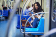 © AK Coop/peopleimages.com - Train, travel and woman with smartphone for videos on journey, commute and passenger on metro. Public transport, railway and person on phone for social media, internet streaming and website on subway