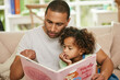 © Siphosethu/peopleimages.com - Father, girl child and reading book on sofa for family bonding, learning and development in lounge. Dad, kid and together in home for storytelling with fairytale, parent teaching and childhood growth