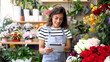 © PeopleVideos - Smiling florist enjoying while running her business