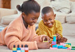 © peopleimages.com - Children, playing and building blocks in home for growth, child development and learning for motor skills. African kids, toys and colorful puzzle in education, skill and cognitive ability for bonding