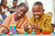 © peopleimages.com - Children, portrait and playing with building blocks in home for growth, child development and learning for motor skills. African kids, happy and toy puzzle in education, skill and cognitive ability