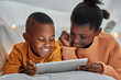 © peopleimages.com - Black kids, tablet and streaming movie in home, happiness and relax together for cartoon in bedroom. Children, siblings and internet for online gaming on bed, entertainment and subscription for media
