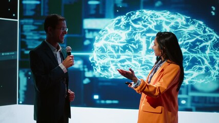 Poster - Presenter and guest chatting during AI summit discussion panel bringing together tech companies, exploring latest developments in artificial intelligence industry and emerging technologies, camera A