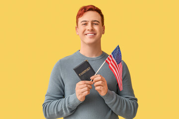 Canvas Print - Handsome young happy man with USA flag and passport on yellow background