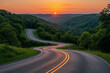 © Carmen - Winding two lane road through countryside hills, sunset or sunrise in horizon, life changes concept, copy space