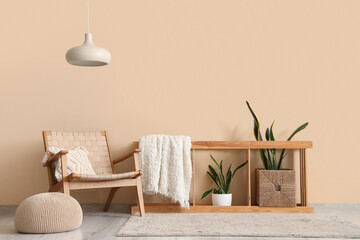 Wall Mural - Interior of stylish living room with armchair and houseplants near beige wall