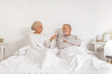 Poster - Mature woman after chemotherapy with her husband lying in bedroom