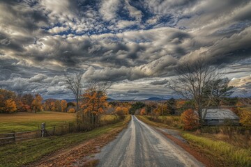 Wall Mural - Stunning hdr landscape featuring a country road amid fall foliage under a dynamic cloudy sky