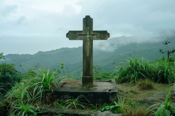 Tranquil misty mountain cross monument in a foggy landscape. A symbol of faith and spirituality in nature. A serene christian symbolism. A spiritual journey in a remote and grave memory