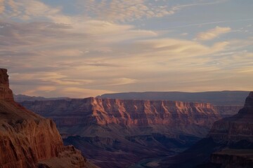 Wall Mural - A canyon at sunset with the sky painted in warm oranges and pinks, casting shadows on the rocky landscape, Generative AI