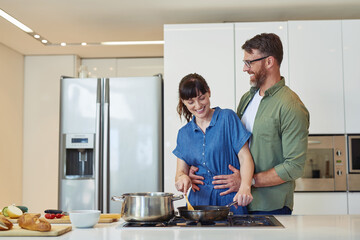 Poster - Smile, hug and couple with cooking in kitchen for meal prep, healthy diet and romantic dinner together. Happy, man and woman with food ingredients by stove for marriage, support and nutrition at home