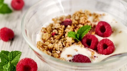 Poster - bowl with cereal, yogurt and raspberries fruits