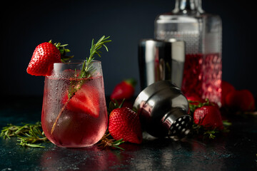 Wall Mural - Cocktail with ice, strawberries, and rosemary.