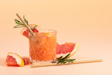 Wall Mural - Summer cocktail with grapefruit, rosemary, and ice in a crystal glass.