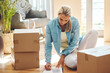 © Penn/peopleimages.com - Woman, new home and document by boxes on floor for mortgage loan, investment or property agreement. Mature person, writing and cardboard in house for real estate, relocation or signature on paperwork