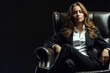 © StokHunt - A glamorous snapshot of a business woman. A girl, an office worker, is sitting in a leather armchair.