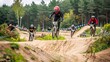© anantachat - Group of senior BMX riders performing tricks and jumps at a bike park Stock Photo with copy space