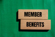 © Emre Akkoyun - Member benefits message written on wooden blocks with green background. Conceptual member benefits symbol. Copy space.