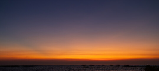 Wall Mural - The sky is a beautiful orange color with a few clouds