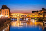 Ponte Vecchio bridge and Arno river waterfront in Florence evening view