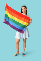 Poster - Beautiful young woman with LGBT flag on blue background