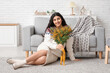 © Pixel-Shot - Beautiful young woman with bouquet of mimosa flowers at home