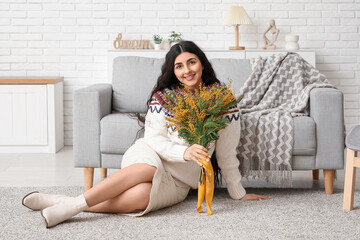 Wall Mural - Beautiful young woman with bouquet of mimosa flowers at home