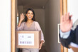 © Hira/peopleimages.com - Wave, delivery and good bye for courier, woman or package for shipment from online shopping. Happy, front door or retail for import logistics from female person, ecommerce or customer for cargo goods