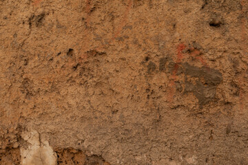 Poster - A rough textured wall with patches of reddish brown paint