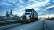 © Darcraft - A semi-truck hauling a tanker trailer drives down a straight highway towards a colorful sunset.