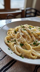 Wall Mural - Alfredo pasta dinner with creamy white sauce and herbs