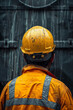 © Hew Pallot - backview of construction worker in yellow vest and hardhat