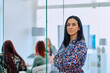 © .shock - Portrait of a Confident Businesswoman with Crossed Arms in Her Office Environment.