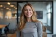 © CogniLens - Portrait of a happy woman in her 30s sporting a long-sleeved thermal undershirt in front of sophisticated corporate office background