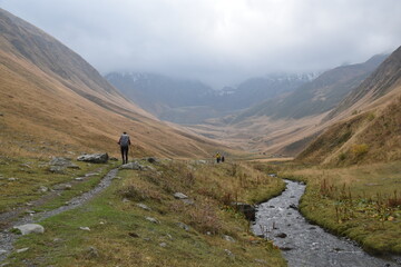 silhouette of a hiker in rain clothes in some misty mountains in georgia