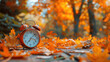 © Thanos - Close-Up of Alarm Clock and Vibrant Orange Leaves on Wooden Background