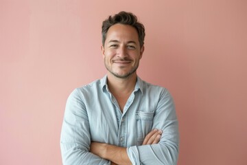 Wall Mural - Portrait of a satisfied man in his 30s wearing a simple cotton shirt over pastel or soft colors background