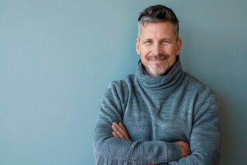 Portrait of a merry man in his 40s dressed in a comfy fleece pullover in pastel or soft colors background