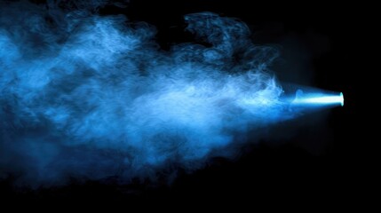 Poster - A blue spotlight shining through a thick cloud of smoke, creating a mysterious and captivating visual effect on a black background.