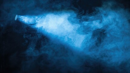 Poster - A blue spotlight shining through a thick cloud of smoke, creating a mysterious and captivating visual effect on a black background. 